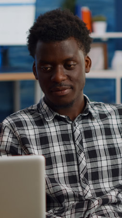 Young interracial couple chatting on video call conference in living room. Multi ethnic people...