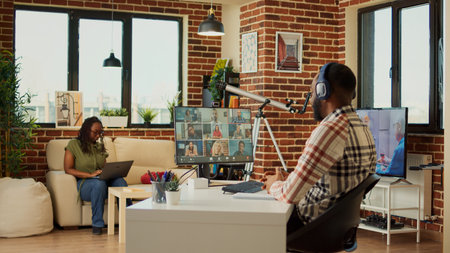Company employee attending online videocall meeting at home, talking to colleagues on teleconference...