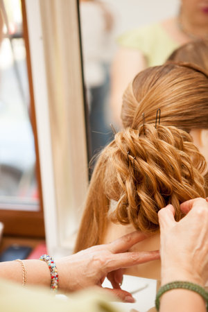 Working in the salon on a new hairstyle. Beauty and fashion