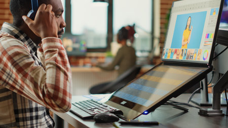 Graphic designer expert editing pictures on touchscreen monitor, using tablet and stylus pen in...