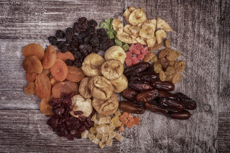 Different type of raw dried fruits on wooden type background in rich HDR toning.の写真素材