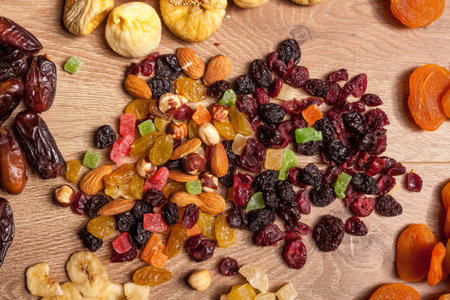 Dried fruits and nuts on wooden background. Healthy food. Fresh raw nuts and fruitsの写真素材