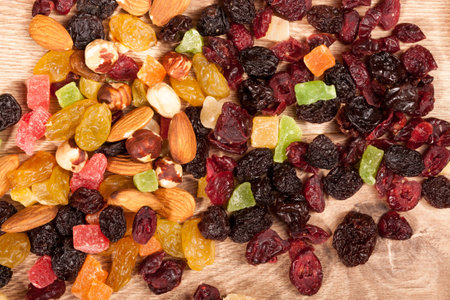 Dried fruits and nuts on wooden background in studio setup. Raw healthy lifestyleの写真素材