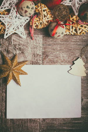 Christmas letter on wooden background with decorations arround. Xmas ornamentsの写真素材