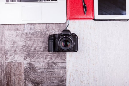 Over top photo of camera and laptop on wooden backgroundの写真素材