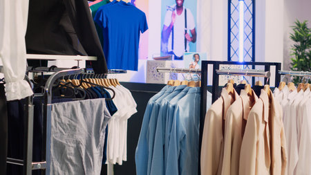 Clothing showroom with casual and formal clothes, retail store with fashion collection on hangers and racks. Clothing store in mall shopping center, lifestyle boutique merchandise on discount.の写真素材