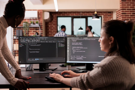 Programming engineers using computer to write code and develop algorithm program. Software developers working on user interface with html script and terminal window in development company.の写真素材