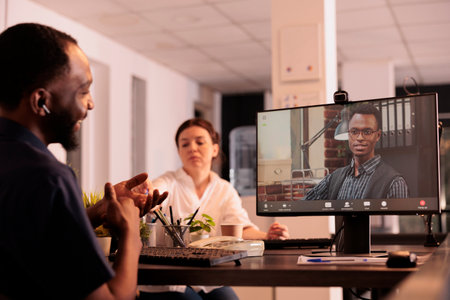 Remote coworkers talking on corporate videocall using webcam software on computer, employees discussing business plan on online meeting. Businessman listening to colleague on videoconferenceの写真素材