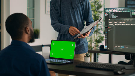 Diverse coders working on code developing and using greenscreen in IT agency office, programming...