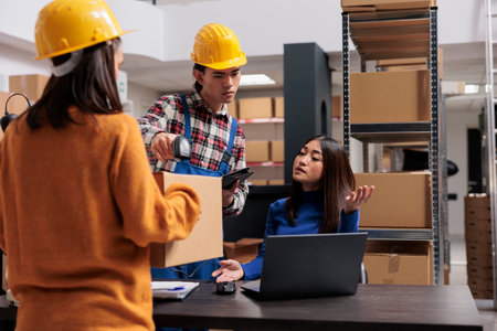 Delivery service managers asian team supervising parcels receiving and sending. Retail warehouse...