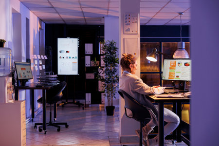 Businesswoman working overhours at company strategy, analyzing financial graphs report in startup...