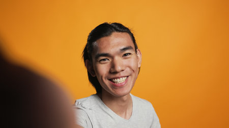 POV of happy person chatting on videocall conference, using internet teleconference chat for remote conversation. Young man having fun with online videoconference meeting on camera.の写真素材