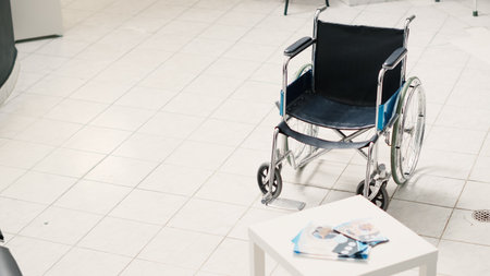 Empty clinic with counter and wheelchair in hospital reception area, front desk with registration...