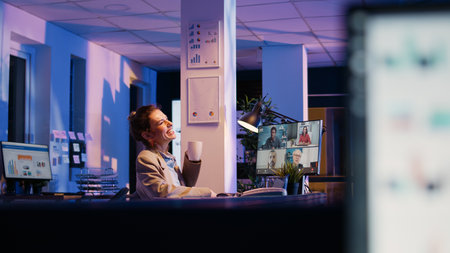 Young manager attending business meeting online using videoconference and webcam on computer,...