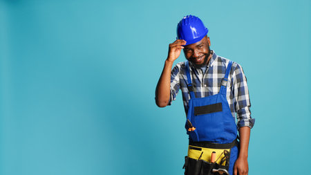 African american craftsman being humble saying hello, acting positive and smiling in studio. Young...