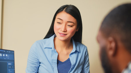 Asian industrial engineer helping 3d editor to develop cad prototype, doing teamwork with graphic software in creative agency office. Coworkers planning engineering development with skills.の写真素材