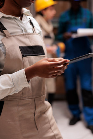 Warehouse supervisor controlling goods inventory on digital tabletの写真素材