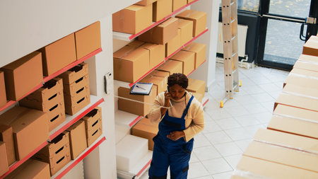 Female worker answering landline phone on wall
