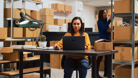 Asian owner doing supplies logistics with laptopの写真素材