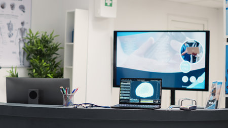 Laptop running brain diagnosis on deskの写真素材