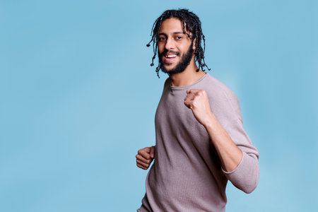 Happy handsome arab man dancing and partying