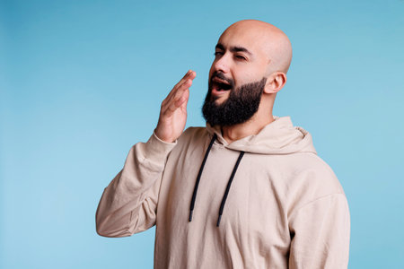 Arab man looking sleepy while yawningの写真素材