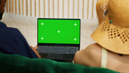 Couple using greenscreen on laptopの写真素材
