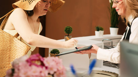 Tourists registering at front deskの写真素材