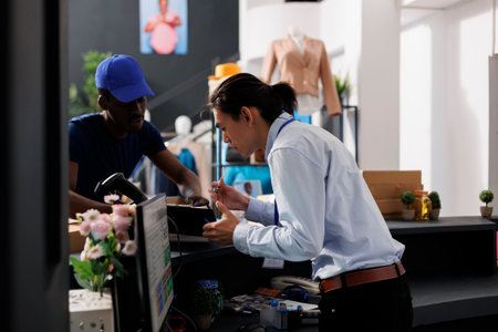 Courier showing document to workerの写真素材