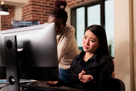 Thoughtful engineers brainstorming ideas to write code and create security program, displaying...