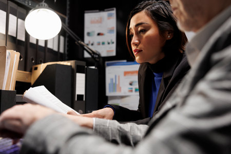 Accounting business executives coworkers imputing bookkeeping analytics data on laptop. Teamworking elderly businessman and asian collegue in administrative archival depository storage officeの写真素材