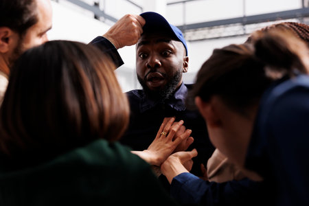 Crowd going crazy during Black Friday, people shoppers pushing back shocked African American man security guard standing at store entrance. Bargain hunters breaking into shopping mallの写真素材