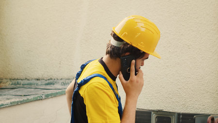 Expert in phone call with customer after finishing condenser maintenance checkup. Competent mechanic...