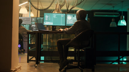 Male spy creating breach of security after gaining access to network system, hacking computer to...
