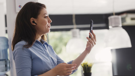 Agency worker using videocall meeting on phone talking to people on online teleconference call....