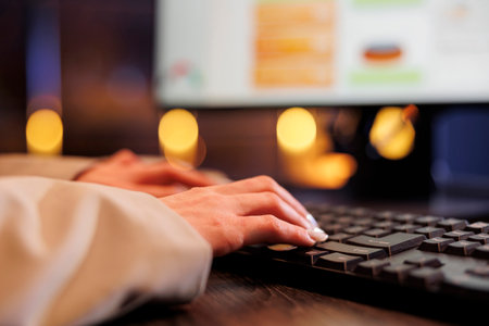 Businesswoman typing financial strategy on computer, analyzing marketing graphs report. Executive manager working late at night at company investment project in startup office. Corporate conceptの写真素材