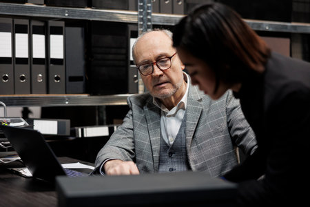 Professional accountancy executives imputing bookkeeping administrative data paperwork on laptop....