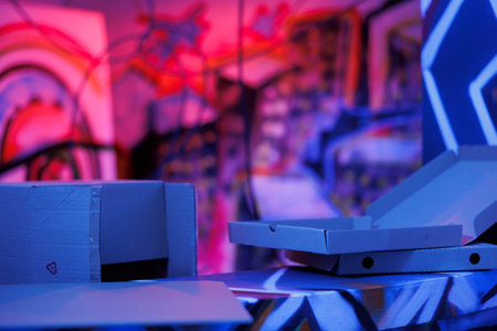 Crumbling structure with purple and pink lights glowing in darkness of chaos and disrepair. Empty deserted building with graffiti art on rusty walls, looking grungy. Fluorescent bright light.の写真素材