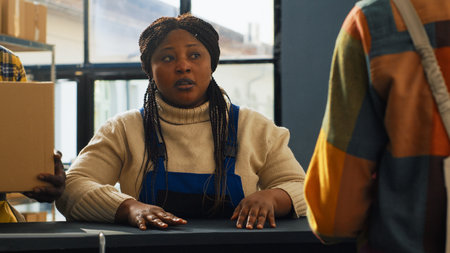 Group of workers doing quality control in warehouse, planning shipment with products distribution in cardboard boxes. Young employees working on stock logistics for retail store transport.の写真素材