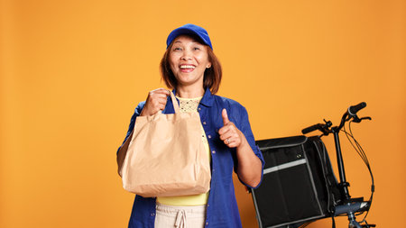 Slow motion portrait shot of bored food delivery bike rider waiting for customer, showing exultant...