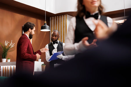 Employee writing guest information for check in process, giving assistance for easy registration....