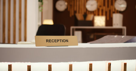 Close up shot of hospitality industry hotel lobby modern clean reception front desk. Empty travel accommodation check in counter in stylish luxurious resort lounge interiorの写真素材