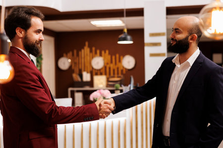 Business partners agreeing on collab, travelling for work to attend important corporate meeting. Two executive managers shaking hands in agreement to start fruitful partnership.の写真素材