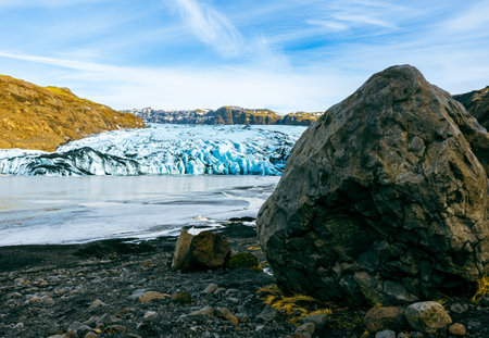 Big vatnajokull glacier cap in iceland next to frozen water in polar landscape, massive diamond shaped ice blocks in cold winter nature. Scandinavian arctic iceberg lagoon and icy rocks.の写真素材