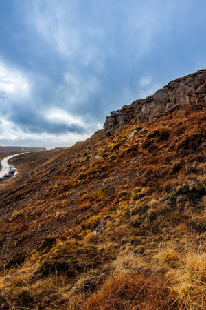 Northern hilltops in icelandic scenery with frozen fields or lands, rocky mountain chain in iceland. Sightseeing spectacular arctic nature and landscapes, natural valley scenic route.の写真素材