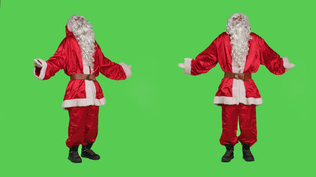 Doubtful saint nick raise shoulders on full body greenscreen, doing i dont know confused gesture feeling uncertain on camera. Santa in costume acting unsure about answer, person shrugging.の写真素材