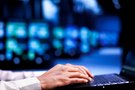 Close up shot of admin in cloud computing business using laptop to set up configuration management tools that enable automatic failover and load balancing, preventing server racks system crashの写真素材