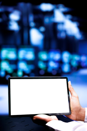 Developer using mock up tablet to mend servers helping businesses manage databases, host websites and store files. Programmer servicing supercomputers used for high performance computing, close upの写真素材