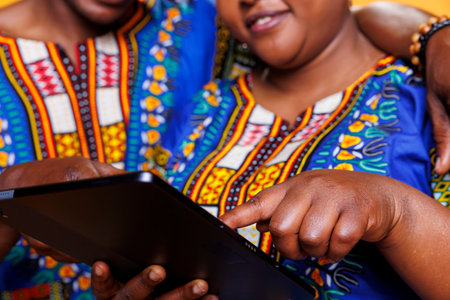 African american man and woman holding digital tablet and tapping with finger on screen closeup. Romantic couple in love hugging and using portable device, pressing touchscreenの写真素材