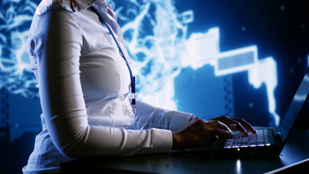 Tech support employee writing artificial intelligence script code in startup workspace on laptop terminal. Efficient IT executive doing maintenance work in high tech facility updating AI systemsの写真素材